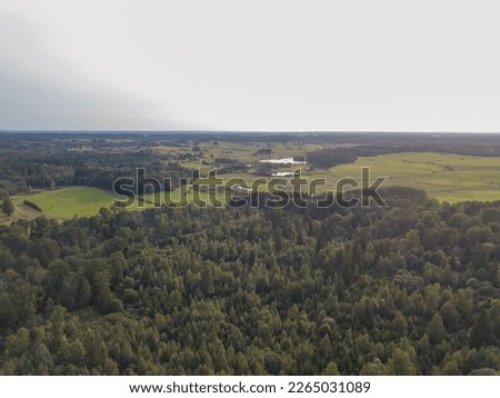 Drone photography of forest, agriculture fields and farmlands during summer day