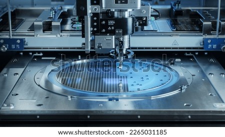 Semiconductor Wafer after Dicing Process. Silicon Dies are Being Extracted by Pick and Place Machine. Computer Chip Manufacturing, Packaging Process. Royalty-Free Stock Photo #2265031185