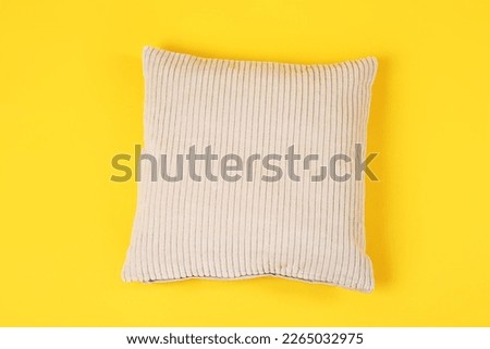 Soft pillow on yellow background Royalty-Free Stock Photo #2265032975