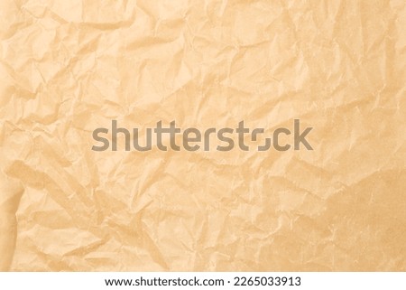 Crumpled sheet of baking paper as background, closeup Royalty-Free Stock Photo #2265033913
