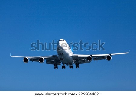 A Boeing 747-422 beginning its descent towards the airport. Royalty-Free Stock Photo #2265044821
