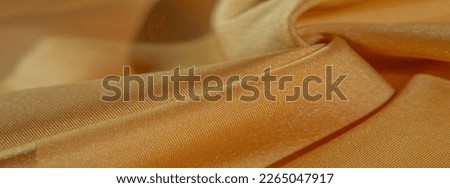 Silk fabric in yellow color. texture of colored silk fabric - can be used as a background