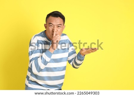 The 40s adult Asian man with standing on the yellow background.