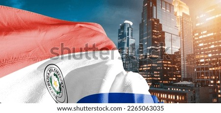 Paraguay national flag cloth fabric waving on beautiful buildings background. Royalty-Free Stock Photo #2265063035