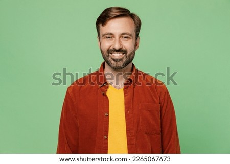 Elderly smiling cheerful fun cool positive satisfied caucasian man 40s years old he wears casual clothes red shirt t-shirt look camera isolated on plain pastel light green background studio portrait