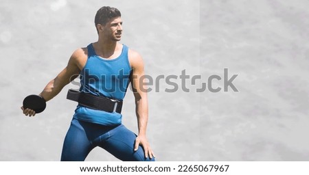 Composition of male discus thrower with copy space on grey background. sport and competition concept digitally generated image. Royalty-Free Stock Photo #2265067967