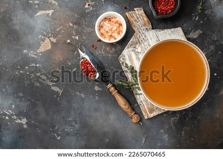 Bone meat chicken broth in a bowl on a dark background, banner, menu, recipe place for text, top view.