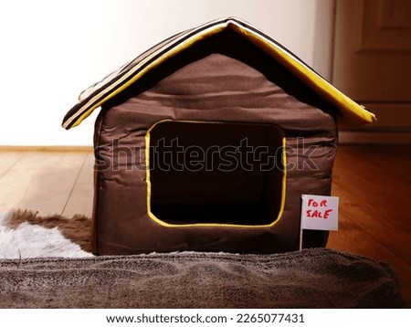 Real estate for sale sign on cat pet house medium shot selective focus