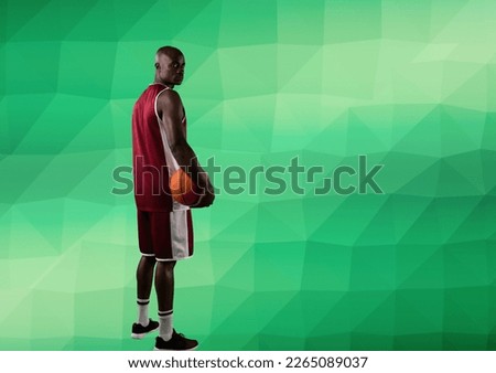 Composition of african american male basketball player with ball and copy space on green background. sport and competition concept digitally generated image.