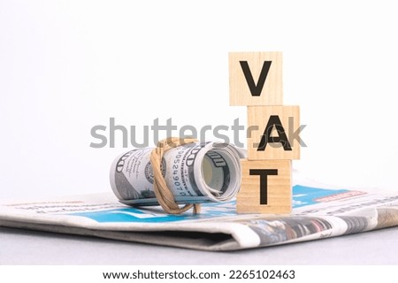 text VAT on wooden cubes over blur background with copy space, financial concept background