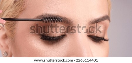 Perfect eyebrows. Natural beauty brows. Eyebrows coloring and lamination. Woman combing eyebrows. Makeup and cosmetology concept. Eyebrow shape modeling.