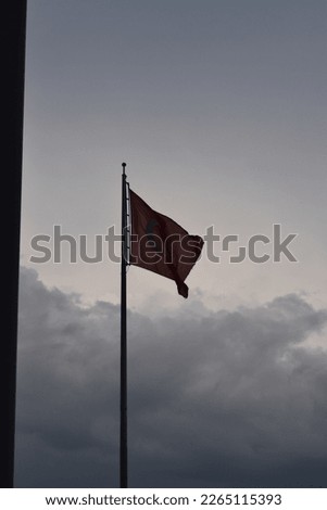 the flutter of the glorious Turkish Flag in a cloudy sky.