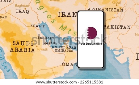 A Smartphone displaying the Circle Flag of Qatar next to Qatar of the World Map