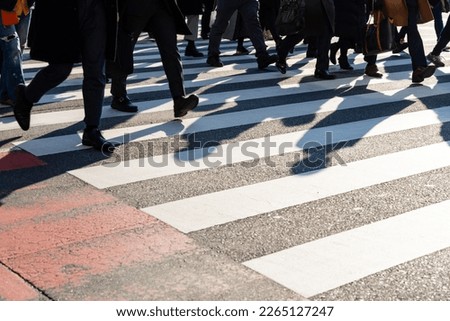 Crowd of Asian business people walking city street crosswalk with traffic on the road at Shibuya crossing, Tokyo, Japan in the morning. Man and woman tourist shopping and travel on holiday vacation. Royalty-Free Stock Photo #2265127247