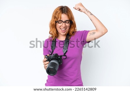 Young photographer caucasian woman isolated on white background celebrating a victory