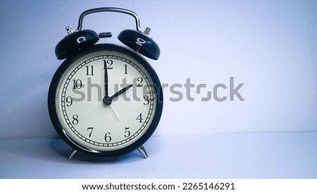 Background photo of an alarm clock showing 2:00 o'clock, isolated on white background