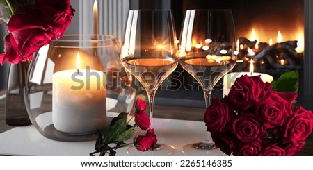 Two glasses of red wine near the fireplace with many candles. Cozy romantic evening for couple or celebration concept design modern home 