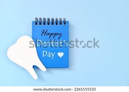 Happy Dentist Day date reminder on blue desk calendar. Celebration concept.