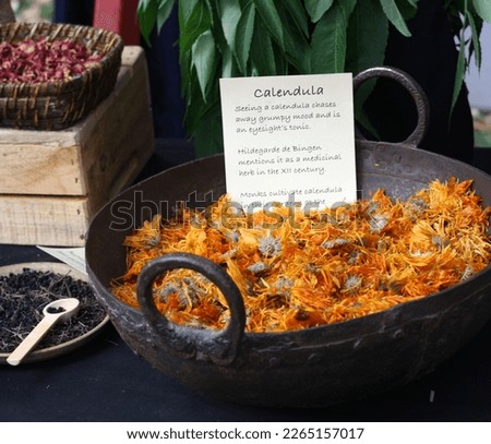 Dried calendula flowers in an old metallic basin - Abbey Medieval Festival, Caboolture, Queensland, Australia