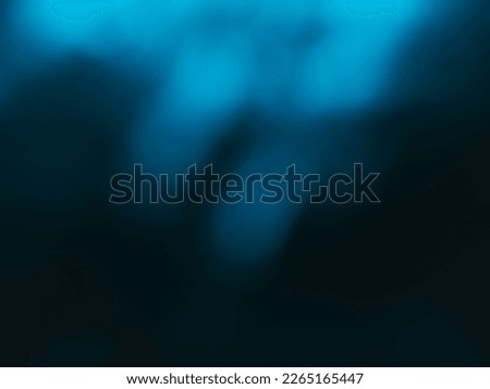 Light blue color blurred in darkness for abstract background.

