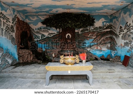 statues of Buddhist gods are neatly displayed in the temple decorated with several ornaments, food and fruit