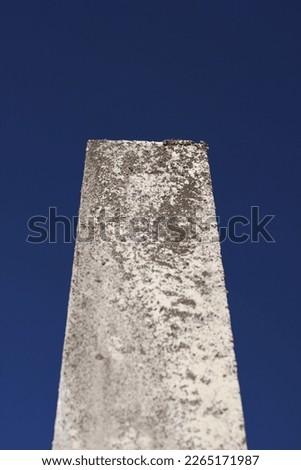 Old, worn, and weathered limestone tombstone monolith with a blank epitaph standing in the aging cemetery. Royalty-Free Stock Photo #2265171987