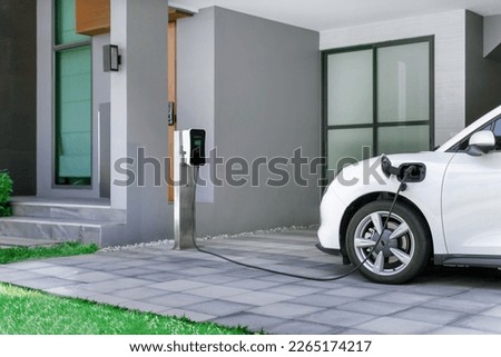 Progressive concept of EV car and home charging station powered by sustainable and clean energy with zero CO2 emission for green environmental. Charging point at residential area for electric vehicle. Royalty-Free Stock Photo #2265174217