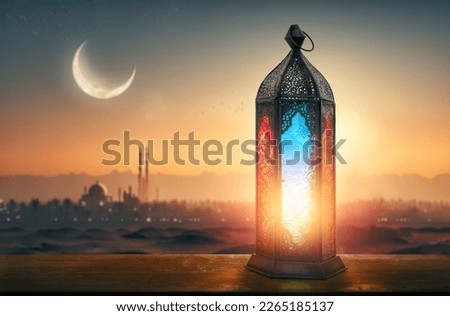 Ornamental Arabic lantern with burning candle glowing at night mosque background. Festive greeting card, invitation for Muslim holy month Ramadan Kareem. Royalty-Free Stock Photo #2265185137