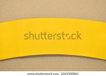 yellow curve paper put on brown background