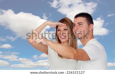 Funny couple looking something with a blue sky of background