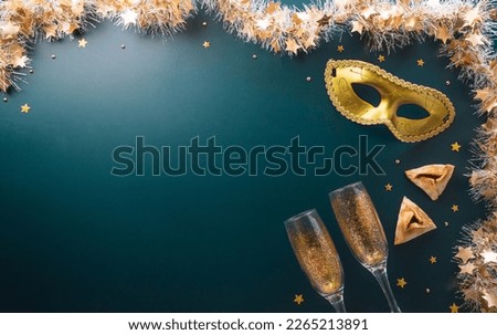 Happy Purim carnival decoration concept made from golden mask star and glitter on dark background. (Happy Purim in Hebrew, jewish holiday celebrate)