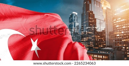 Turkey national flag cloth fabric waving on beautiful buildings background.