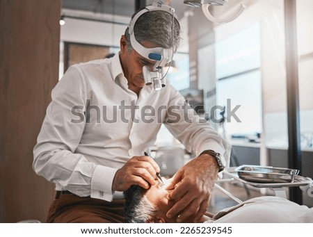 Healthcare, optometry and optometrist doing a cataract surgery on a senior patient in the clinic. Medical, eye care and male optician doing ophthalmology procedure for elderly woman at optical office Royalty-Free Stock Photo #2265239545