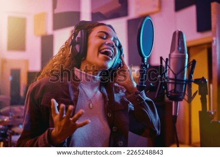 Recording, music and woman singing in a studio for radio, song production and rehearsal. Creative, voice and singer making a record, track or musical sound with a talent as a professional artist Royalty-Free Stock Photo #2265248843
