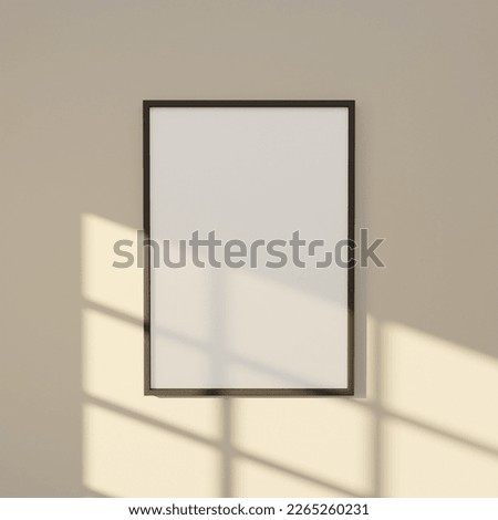 a portrait of 5x7 dark wooden frame mockup poster for your design artwork. frame mockup on the beige wall interior lit by sunlight. Minimalistic concept of home decoration. Royalty-Free Stock Photo #2265260231