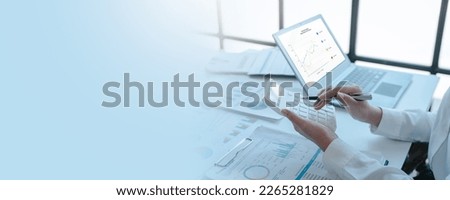 Close up accountant working on consolidated financial report of corporate operations, consultant auditing finance data (balance sheet, income statement) fintech. Royalty-Free Stock Photo #2265281829