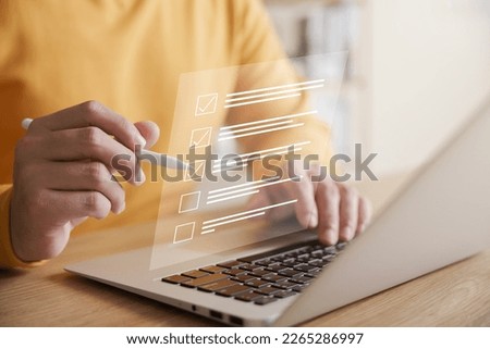 Business performance checklist concept, businessman using laptop doing online checklist survey, filling out digital form checklist. Royalty-Free Stock Photo #2265286997