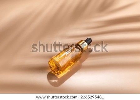 Dropper glass Bottle Mock-Up. dropper pipette with serum or essential oil on beige backgound with caustic shadows for product presentation. Skincare cosmetic. Beauty concept for face body care. Royalty-Free Stock Photo #2265295481