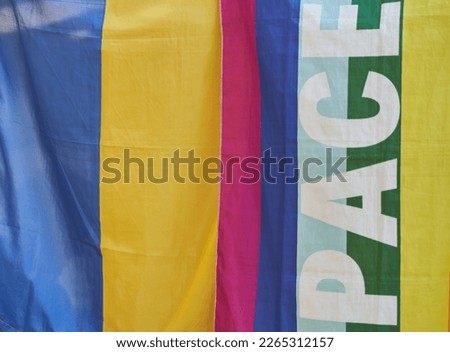 The flag of Ukraine and the LGBT flag are sold in a street tent. High quality photo