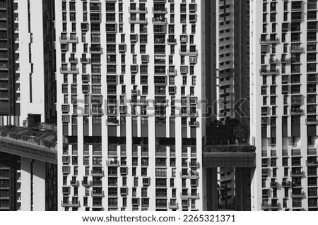 Facade of The Pinnacle, a huge apartment building in Singapore, windows creating a contrast with the white structure, black and white