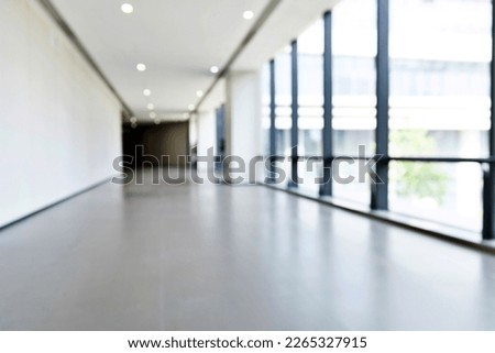 Abstract defocused blurred background of empty long corridor in the modern hospital.