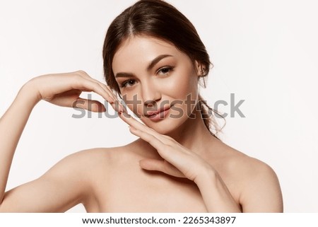 Portrait of young beautiful brunette woman with perfect smooth skin isolated over white background. Clear well-kept skin. Concept of natural beauty, plastic surgery, cosmetology, cosmetics, skin care.