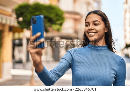 Young african american woman smiling confident making selfie by the smartphone at street