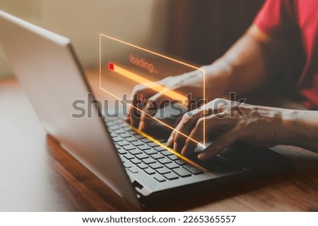 Adult man using a laptop computer for download software and waiting to loading digital business data form website, very slow internet form wifi. Concept of waiting for load of loading symbol.