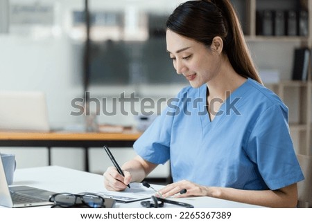 young asian doctor working with laptop computer talking video conference call with patient at desk in health clinic, Consulting and therapy, healthcare and medical concept. 