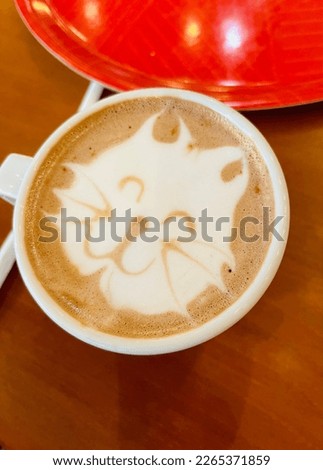 a cup of cocoa with a painted cat, children's theme