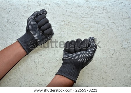 Gray working glove on hand. Open palm on isolated white background.