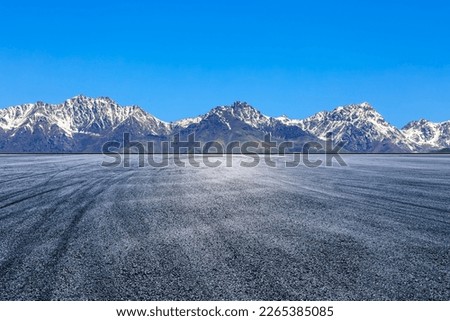 Empty asphalt road and snow mountain natural landscape under blue sky