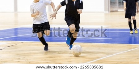 School boys on indoor football tournament game. Football futsal players, ball, futsal floor. Indoor soccer sports hall. Kids compete in indoor soccer duel Royalty-Free Stock Photo #2265385881