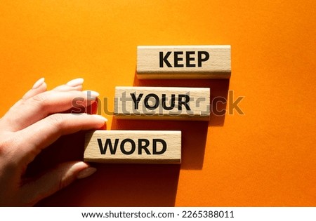 Keep your word symbol. Wooden blocks with words Keep your word. Beautiful orange background. Businessman hand. Business and Keep your word concept. Copy space.